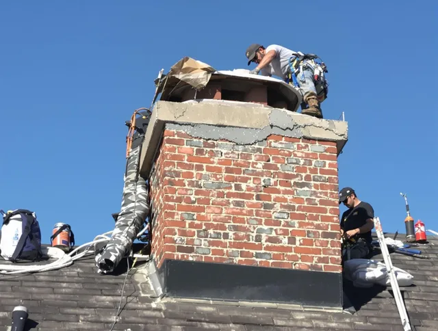 Marblehead Chimney Sweep installing a custom chimney crown in Marblehead, MA